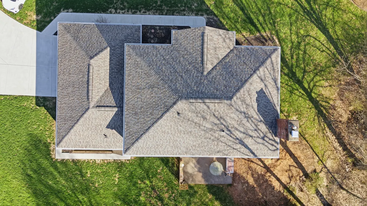 Overhead view of a house with a newly finished grey shingle roof
