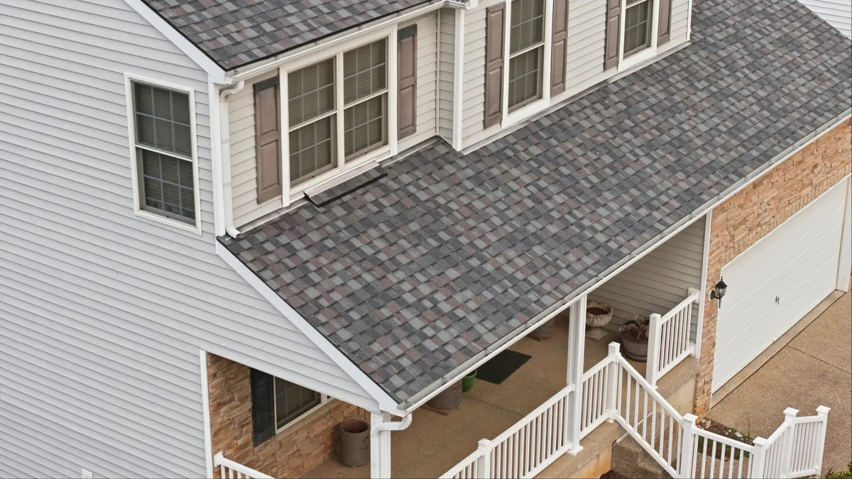 Vinyl siding and a new shingle roof on a two story home, seen from above